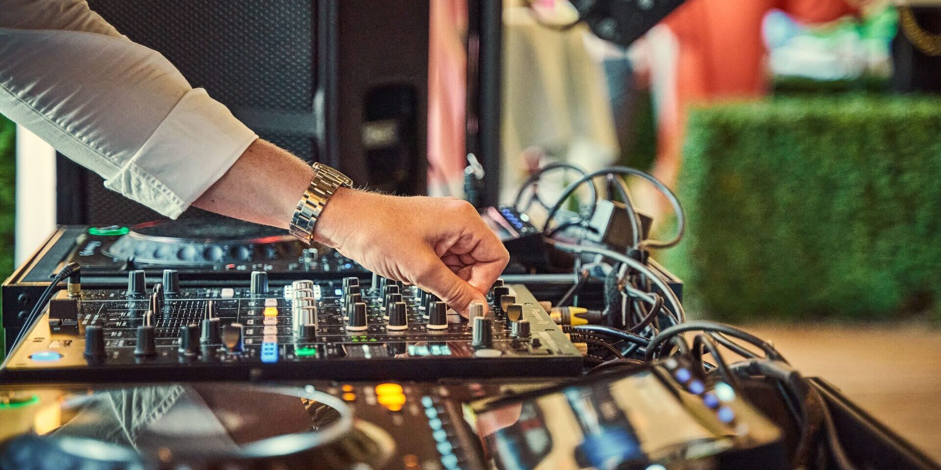 Professional Rochester NY Wedding DJ Setup Professional DJ mixing music on modern audio equipment at an elegant wedding reception in Rochester NY