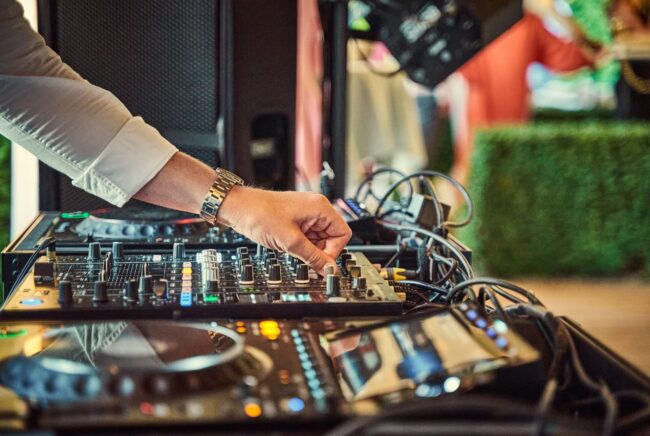 Professional DJ mixing music on modern audio equipment at an elegant wedding reception in Rochester NY