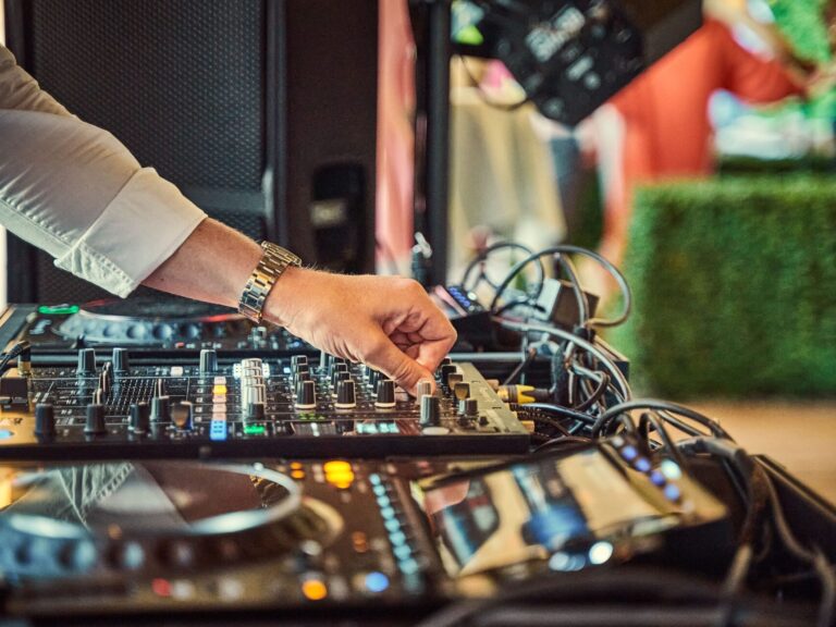 Professional DJ mixing music on modern audio equipment at an elegant wedding reception in Rochester NY