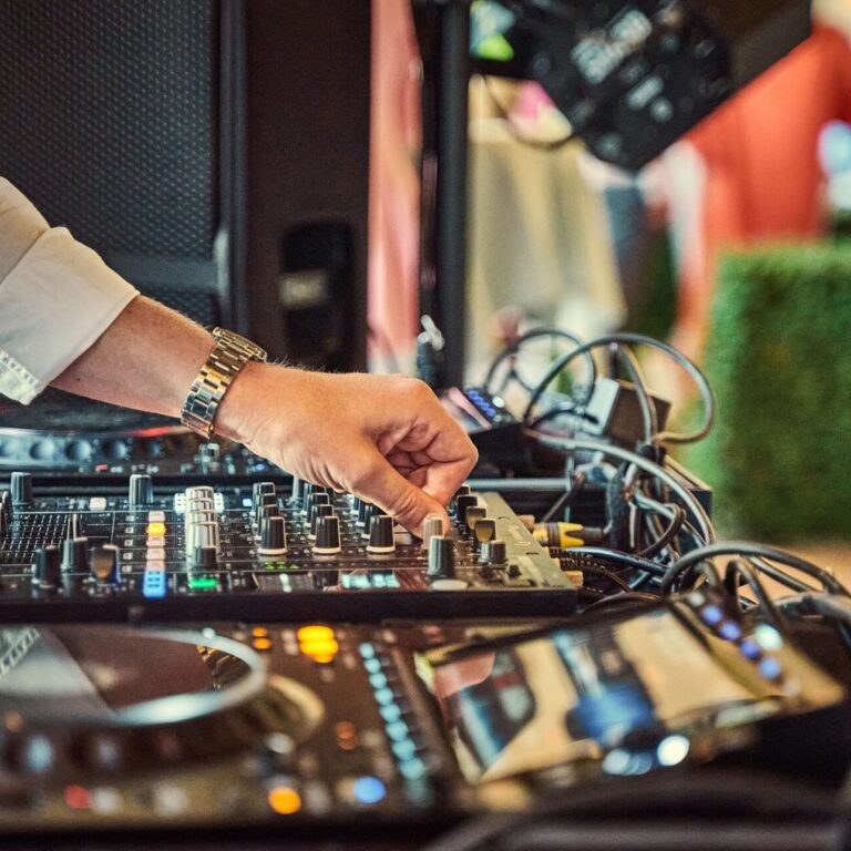 Professional Rochester NY Wedding DJ Setup Professional DJ mixing music on modern audio equipment at an elegant wedding reception in Rochester NY